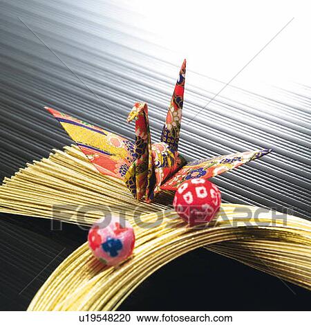 Origami bird on bunch of gold strings, high angle view View Large Photo Image Stock Image - Origami bird on bunch of gold strings, high angle view. Fotosearch