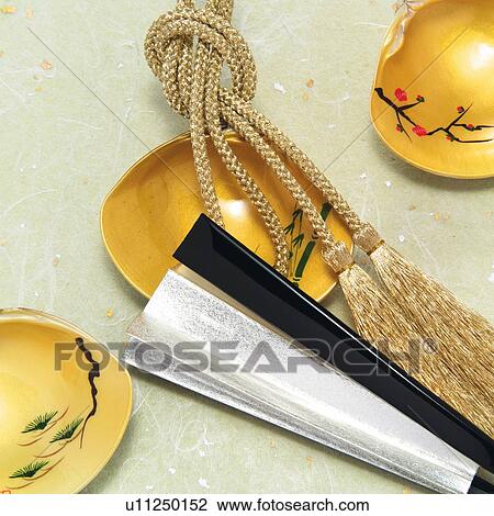 Stock Image - Painted clamshells and Japanese folding fan, high angle view. Fotosearch