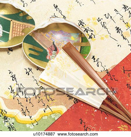 Stock Photo - Painted clamshells and Japanese folding fan on paper written Japanese poem, high angle view. Fotosearch