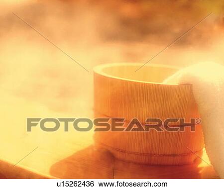 Stock Photograph - Towel on a wooden tub, Japanese wooden bath, soft focus, sepia toned. Fotosearch