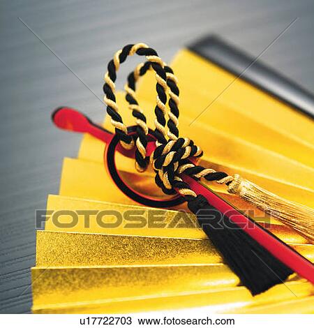 Stock Image - Webbing strap on Japanese folding fan, high angle view, close up, differential focus. Fotosearch