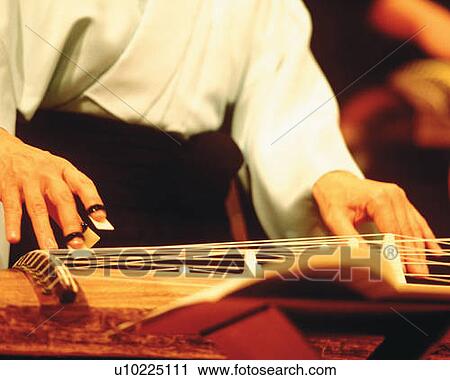 Woman playing Japanese harp, low angle view, differential focus View Large Photo Image Stock Image - Woman playing Japanese harp, low angle view, differential focus. Fotosearch