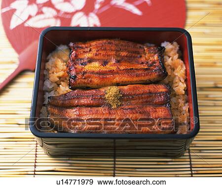 Stock Photo - Broiled eel on rice in box and Japanese fan, high angle view, differential focus. Fotosearch