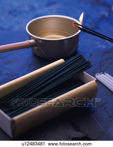 Burning sticks of incense, ladle, candles and incense sticks in box, high angle view, differential focus View Large Photo Image Stock Image - Burning sticks of incense, ladle, candles and incense sticks in box, high angle view, differential focus. Fotosearch