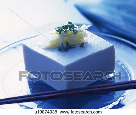 Stock Photo - Cold bean curd on glass plate, high angle view, toned image, differential focus. Fotosearch