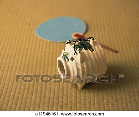 Japanese folding fan and pig-shaped incense burner on Tatami mat, high angle view, Japan View Large Photo Image Stock Image - Japanese folding fan and pig-shaped incense burner on Tatami mat, high angle view, Japan. Fotosearch