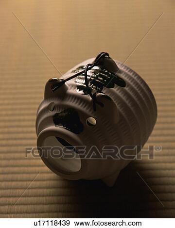 Stock Photo - Pig-shaped incense burner on Tatami mat, high angle view, differential focus, Japan. Fotosearch