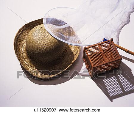 Stock Photo - Straw hat, insect net and insect cage, high angle view, white background. Fotosearch