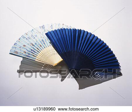 Stock Image - Two Japanese folding fans, front view, white background. Fotosearch