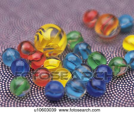 Stock Photo - Colorful marbles, high angle view, differential focus. Fotosearch