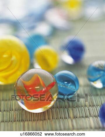 Stock Image - Colorful marbles on Tatami mat, high angle view, differential focus. Fotosearch