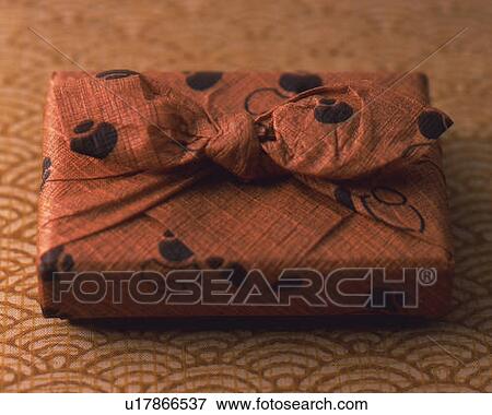 Gift wrapped in a cloth, high angle view, differential focus View Large Photo Image Stock Photo - Gift wrapped in a cloth, high angle view, differential focus. Fotosearch