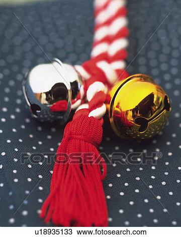 Stock Image - Gold and silver bells put on strap, high angle view, differential focus. Fotosearch