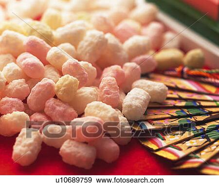 Japanese cubic rice crackers and Japanese folding fan on red surface, high angle view, close up, differential focus View Large Photo Image Stock Photo - Japanese cubic rice crackers and Japanese folding fan on red surface, high angle view, close up, differential focus. Fotosearch