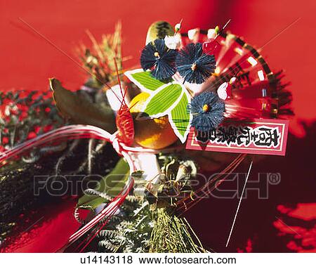 Stock Photo - Japanese lucky charm for business Godspeed, high angle view, red background. Fotosearch