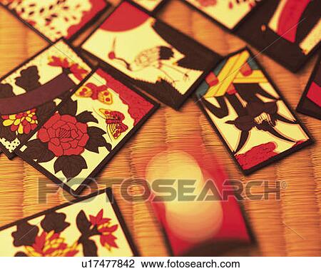 Stock Image - Japanese playing cards on Tatami mat, high angle view, blurred motion, differential focus. Fotosearch