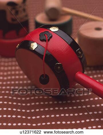 Stock Image - Japanese toy on fabric, high angle view, differential focus. Fotosearch
