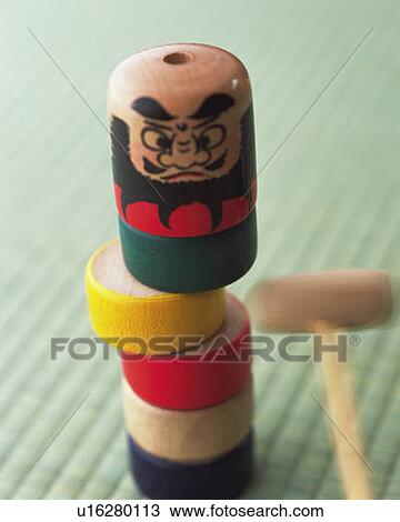 Stock Image - Japanese toy on Tatami mat, high angle view, blurred motion, differential focus. Fotosearch