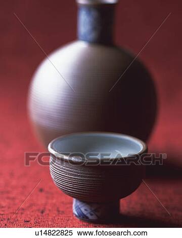 Stock Photography - Sake in cup and bottle, high angle view, differential focus. Fotosearch