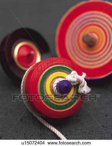 Three spinning tops, high angle view, differential focus View Large Photo Image Picture - Three spinning tops, high angle view, differential focus. Fotosearch