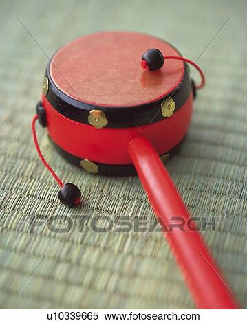 Stock Photography - Toy of hand drum on Tatami mat, high angle view, differential focus. Fotosearch