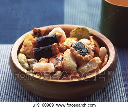 Stock Photo - Various Japanese rice crackers in bowl, high angle view, differential focus. Fotosearch