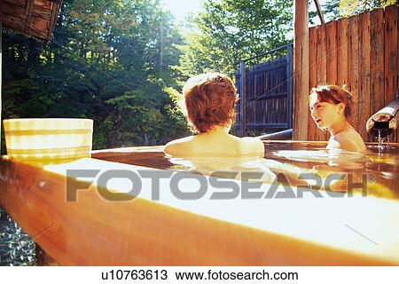 Stock Image - Two Young Adult Women Taking a Bath. Fotosearch