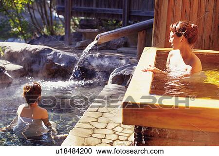 Stock Image - Two Young Adult Women Taking a Bath. Fotosearch