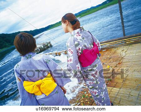 Two Young Adult Womon Standing at Weir View Large Photo Image Picture - Two Young Adult Womon Standing at Weir. Fotosearch