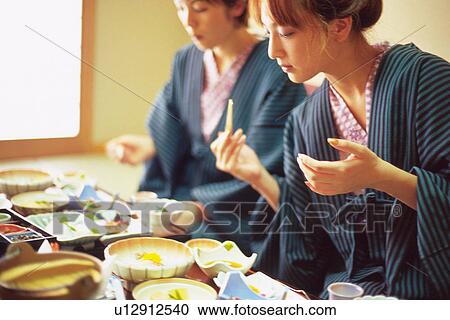 Two Young Woman Eating a Meal View Large Photo Image Stock Image - Two Young Woman Eating a Meal. Fotosearch