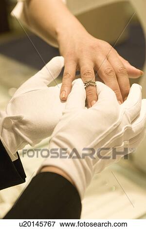 Stock Photo - Body Parts, Trying On Ring. Fotosearch