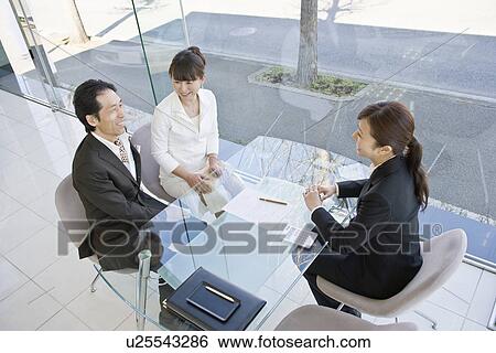 Stock Photograph - Japanese Couple, Business Talking. Fotosearch