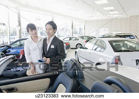 Japanese Couple Looking Of Car View Large Photo Image Stock Image - Japanese Couple Looking Of Car. Fotosearch
