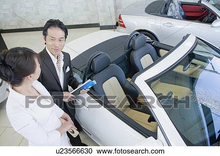 Japanese Couple Looking Of Car View Large Photo Image Stock Image - Japanese Couple Looking Of Car. Fotosearch