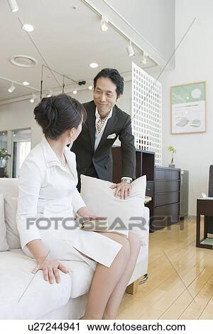 Stock Image - Japanese Couple Looking Of Furniture. Fotosearch