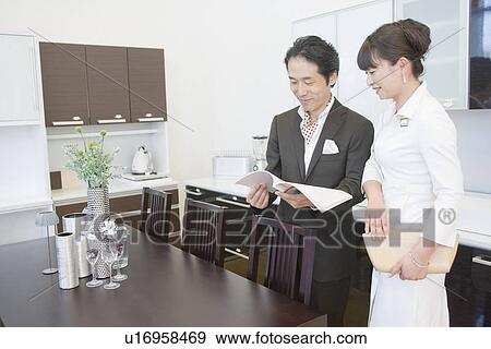Stock Photo - Japanese Couple Looking Of Furniture. Fotosearch
