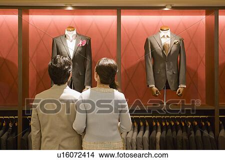 Picture - Japanese Couple Looking Of Suits. Fotosearch