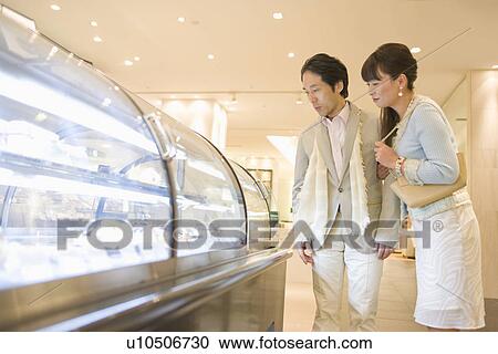 Stock Image - Japanese Couple, Shopping. Fotosearch