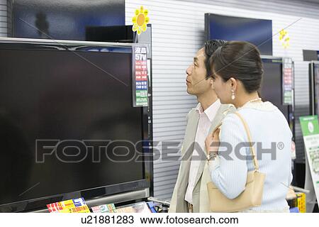 Stock Image - Japanese Couple, Shopping. Fotosearch