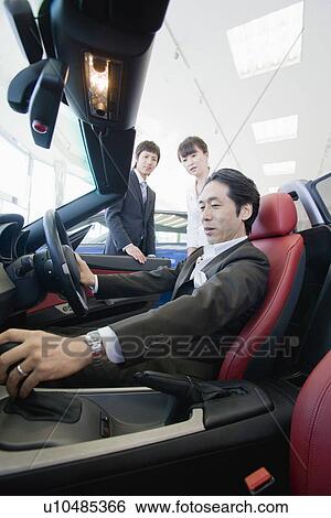Stock Photograph - Japanese Man Looking Of Car. Fotosearch