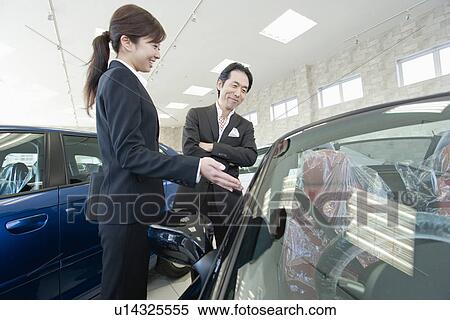 Stock Photography - Japanese Man Looking Of Car. Fotosearch