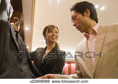 Stock Photo - Japanese Man Looking Of Suits. Fotosearch