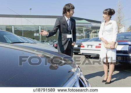 Stock Photo - Japanese Woman Looking for Car. Fotosearch