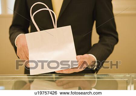 Salesclerk With Shopping Bag View Large Photo Image Stock Photograph - Salesclerk With Shopping Bag. Fotosearch