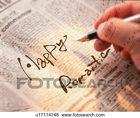Stock Photograph - Man Writing the Words Happy and Romantic on a Newspaper, high angle view, differential focus, Computer Graphics, composition. Fotosearch