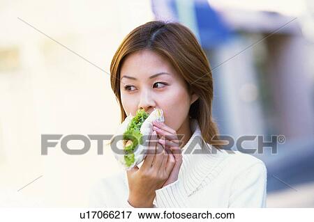 Stock Photo - Cherry flowers on branch under the blue sky, low angle view. Fotosearch