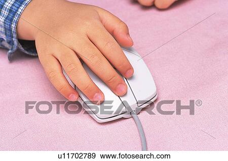 a Little Child's Hand on a computer mouse, High Angle View View Large Photo Image Stock Photo - a Little Child's Hand on a computer mouse, High Angle View. Fotosearch
