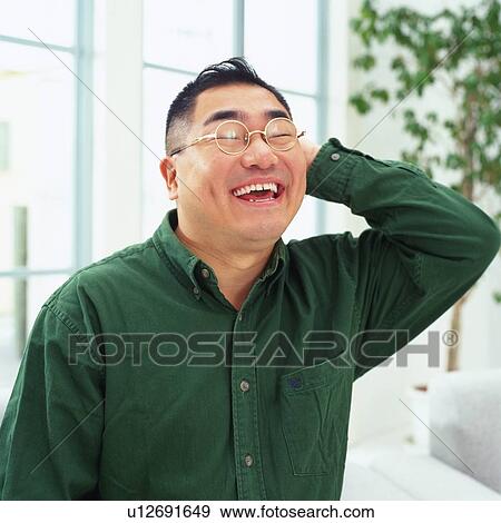 a Mid Adult Man smiling and putting his hand on the back of his head, Side View View Large Photo Image Stock Photo - a Mid Adult Man smiling and putting his hand on the back of his head, Side View. Fotosearch
