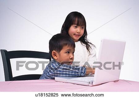 Girl and boy looking at the monitor of a laptop, Side View View Large Photo Image Stock Photography - Girl and boy looking at the monitor of a laptop, Side View. Fotosearch