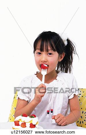 Little Girl eating a strawberry cake, looking at camera, Smiling, Front View View Large Photo Image Stock Photo - Little Girl eating a strawberry cake, looking at camera, Smiling, Front View. Fotosearch
